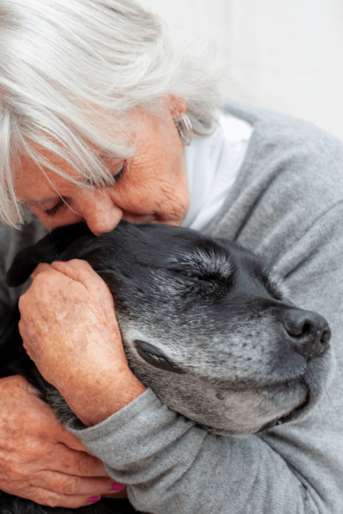 woman hugging dog